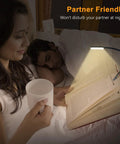 Gritin 9-LED rechargeable clip-on book light clipped to an open book on a bed, illuminating pages