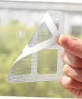 Hand applying DIY Window And Door Screen Patch Kit With 20 Fiberglass Mesh Patches for quick fixes of holes in window screens.