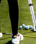 Close-up of Golf Ball Retriever Tube, Detachable Picker Upper For Golf Balls, Aluminum Alloy Shag Bag System Holds Up To 24 Balls on green