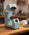 Automated Cap Heat Press Machine With Electric Drive For Smooth Repeating Jobs Dual Platens on workshop table with hats.