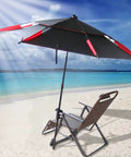 Durable Outdoor Patio Umbrella Clamp Stand And Deck Mount, Clip On Holder attached to a chair on a sandy beach