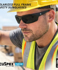 Close up of a man wearing 144 Pack Polarized Gray Antifog Safety Glasses Rock Solid Ansi Z87 Plus on a job site.