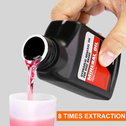 Pouring mineral oil brake fluid into cup, from Two Bottle Pack Mineral Oil Brake Fluid for Shimano Tektro TRP Hydraulic Disc Brakes