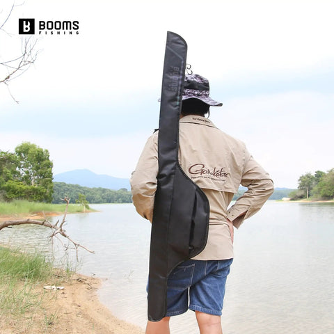 Angler carrying Lightweight Nylon Rod And Reel Case That Stashes 2 To 3 Poles With Reels Folded About Six Inches by a lake