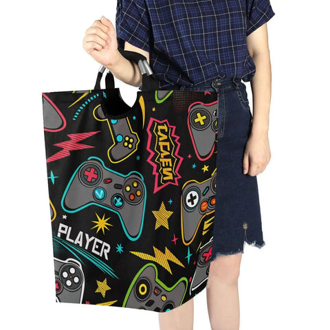 Person holding a Heavy Duty Tough As Nails Laundry Hamper with Handle Foldable 52L Oxford Cloth featuring gamepad design.
