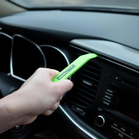 Using Scratch Free Nylon Trim Removal Tool Kit for Auto Molding, Fasteners, And Bezels That Won't Scratch Paint Or Surfaces in a car interior