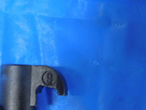 Close-up view of Premium Grind CL-9 Insert Clamp for Indexable Cutting Tools, showing secure locking feature on blue background.