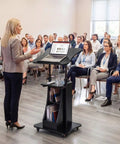 Slick Height Adjustable Standing Desk With Smooth Rolling Casters, Tilting Lectern Stand in use during a presentation.