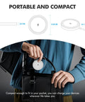 Person holding compact Qi2 fast charging pad from 3 Pack Magnetic Wireless Chargers Set, white, perfect for desk, bedside, travel.