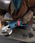 Push Button Switch Replacement Kit For 100mm 4 Inch Angle Grinders And Polishers Durable Plastic And Metal Construction Includes Two Switches For Spare Use Or Dual Tool Setup Easy Install Power Tool Part image showing switches next to a worker using an angle grinder