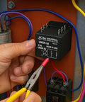 Close-up of ICM UMSR-50 universal motor starting relay in an electrical panel; black rectangular relay with terminal pins and red lead.