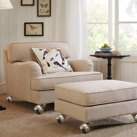 Heavy Duty 2 Inch Ball Casters With Silent Polypropylene Wheels And Antique Brass Swivel Plates Set Of 4 For Vintage Furniture Refreshes on an upholstered chair.