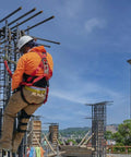 Worker wearing Premium EagleLite Harness With Tongue Buckles And 3 D Rings For Fall Safety at construction site