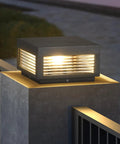 Outdoor LED Post Light With Square Lantern Style, 9.84 Inch Hardwired Aluminum Glass Post Lamp on stone fence at dusk