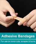Adhesive bandage being applied to a finger; beige skin-tone strip.