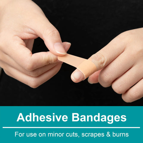 Adhesive bandage being applied to a finger; beige skin-tone strip.