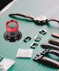 Pro Grade Metal Loupe Magnifier For Watch Repair And Jewelry Making with watch parts on green grid surface