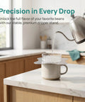 Total Game Changer Metal Coffee Drip Assist Tool And Portable Pour Over Dripper Stand with kettle pouring water into a mug.