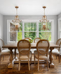 Modern Lantern Pendant Light With Four Lights In A Rusty Gold Finish hanging over dining table