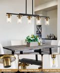 Top Notch Five Light Dining Room Fixture Featuring Clear Glass Shades, black gold metal, and E26 base above a table.