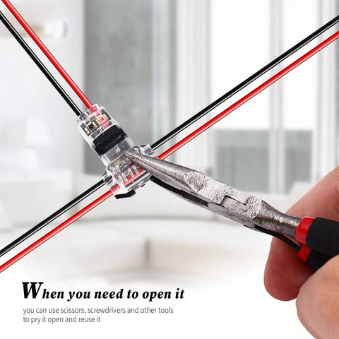 Using pliers to open a 48 Pack Low Voltage 2 Pin 2 Way Wire Connector For DIY Wiring Projects, clear housing, indoors.