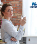 Person holding a glass of water in a kitchen, emphasizing fresh water provided by XWF Refrigerator Water Filter Replacement MR-XWF Model.