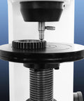 Rock Solid Digital Rockwell Hardness Tester With Four Inch Color Touch Screen and Motorized Build measuring gear on black platform.