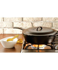 Heavy-Duty Cast Iron Covered Deep Skillet With Lid, 5 Quart on stove, pre-seasoned cooking, next to seasoning bowl