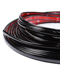 Side view of coiled glossy black SBWLKJ automotive trim molding, 1/2 in wide, self-adhesive.