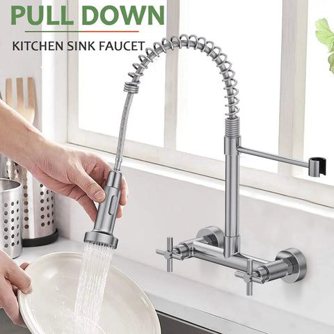Rock Solid Wall Mount Kitchen Faucet With Smooth Dual Handles And No Fuss Two Function Spray For Laundry Or Commercial Sinks Built Tough From Lead Free Brushed Nickel Stainless Steel, shown in use with a pull-down spray for easy dish cleaning.