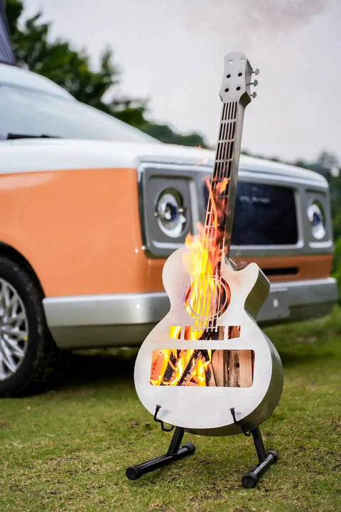 Guitar Shaped Outdoor Fire Pit Stainless Steel Wood Burning With Removable Ash Pan Stand And Carry Bag For Patio Yard Camping Garden Picnic And Bonfire Heating on lawn next to car.