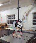 Heavy Hitter Table Saw Dust Collection Guard handles up to 16 inch blades with 45 degree tilting boom in workshop.