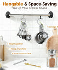 13 Piece Stainless Steel Measuring Cups and Spoons Set with Funnel for Baking and Cooking hanging on kitchen rack.