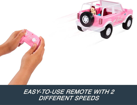 Hands holding remote for Ford Bronco Remote Control RC Car for Barbie with Puppy Accessories, Fits Two Dolls, Two-Speed Drive