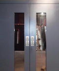 Double doors with stainless steel pull handles and plate installed, barn door hardware visible, handles 7 7/8 inch by 2 9/16 inch wide.
