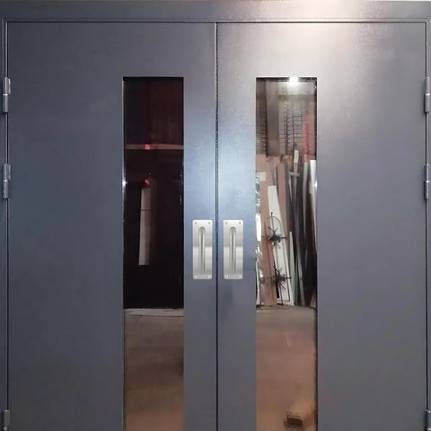 Double doors with stainless steel pull handles and plate installed, barn door hardware visible, handles 7 7/8 inch by 2 9/16 inch wide.