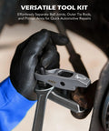 Front view of an OMT ball joint separator and pitman arm puller in gray metal held by a black-gloved hand.