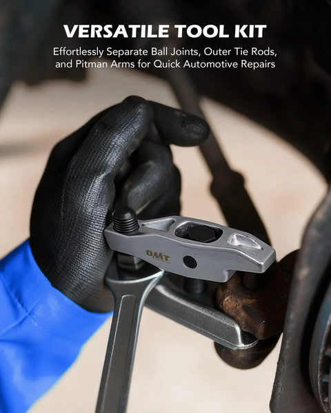 Front view of an OMT ball joint separator and pitman arm puller in gray metal held by a black-gloved hand.