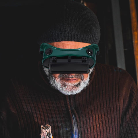 Heavy Duty Double Flip Welding Goggles With Impact Resistant Lenses And Smooth Flip Mechanism worn by a man in a workshop.