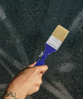 2 Inch Adjustable Angled Paint Brush For Fine Detail And Corners, Synthetic Bristles shown against textured wall