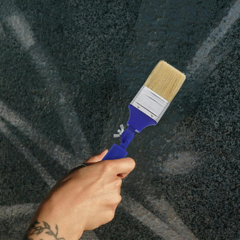 Hand holding a Two Inch Adjustable Angled Paint Brush Versatile Workhorse For Walls Acrylic And Oil Painting Flat Tip Craft Brush