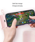 No Sweat Battery Charging Case For Rechargeable Cells Solderless DIY Power Bank Housing charging a smartphone while gaming.