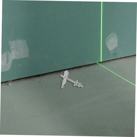Heavy Duty Toggle Bolt Installation Kit With Adjustable Clamping For Drywall And Hollow Walls, shown on green drywall