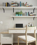 8 Piece L Shaped Metal Shelf Brackets For Wall Mounts supporting white floating shelves above a desk with books and plants