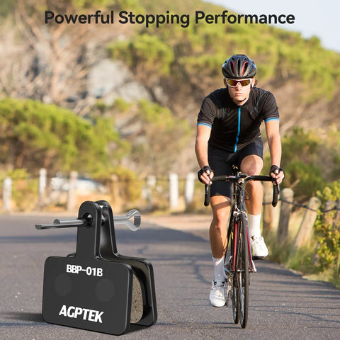 Cyclist on road with Beefy Stopping Power Low Noise Resin Disc Brake Pads For Mountain Bikes, 4 Pairs, Black shown in foreground.
