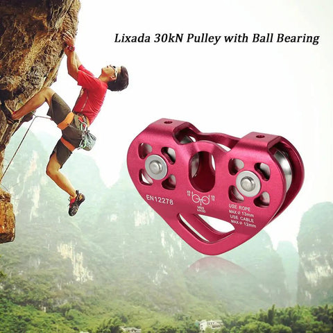 Climber ascending rock next to red 30KN double sheave pulley trolley for zipline with stainless steel bearings and alloy shell.