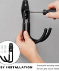 Person installing Heavy Duty Metal J Hook Ev Charger Holder With Non Slip Coating on a wall, showcasing easy setup.