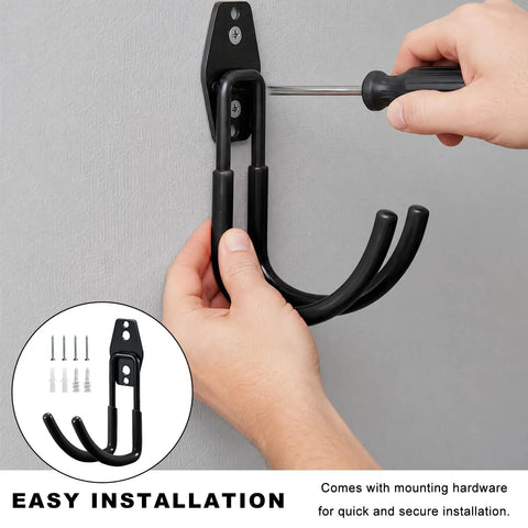 Person installing Heavy Duty Metal J Hook Ev Charger Holder With Non Slip Coating on a wall, showcasing easy setup.