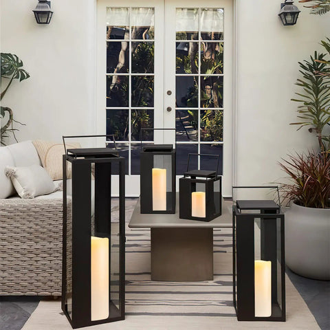 Outdoor patio with Large 4x10 Waterproof Outdoor Flameless Candles Battery Operated LED Pillar Lights in black lanterns.