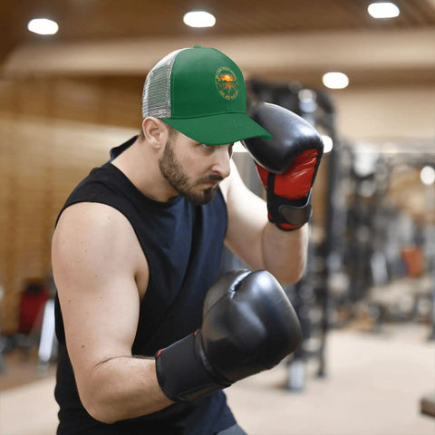 Man boxing in gym wearing Green Trucker Cap For Men And Women, Casual Sport Hat With Adjustable Buckle, Front Graphic Design